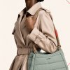 کیف دوشی پف‌دار برند توپولوژی با بند طنابی دو رنگ و لوگوی سفید در استایل | Padded Topologie shoulder bag with contrast rope strap and white logo, in-hand