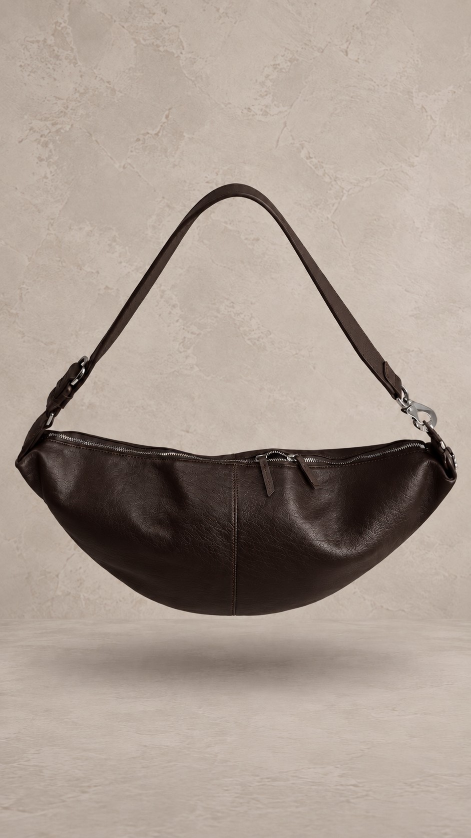 کیف دوشی هلالی چرمی به رنگ قهوه‌ای تیره با بند پهن و یراق‌آلات نقره‌ای | Dark brown crescent-shaped leather hobo bag with wide strap and silver-tone hardware