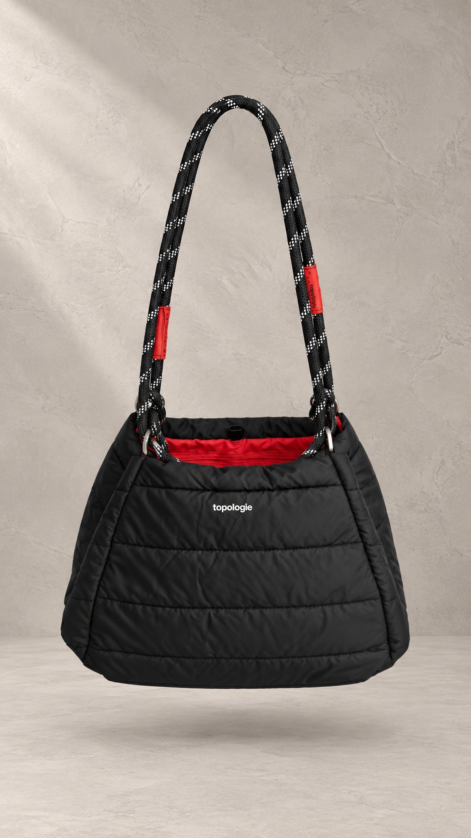 کیف دوشی پف‌دار برند توپولوژی با بند طنابی دو رنگ و لوگوی سفید در استایل | Padded Topologie shoulder bag with contrast rope strap and white logo, in-hand