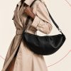 کیف دوشی هلالی چرمی به رنگ قهوه‌ای تیره با بند پهن و یراق‌آلات نقره‌ای | Dark brown crescent-shaped leather hobo bag with wide strap and silver-tone hardware