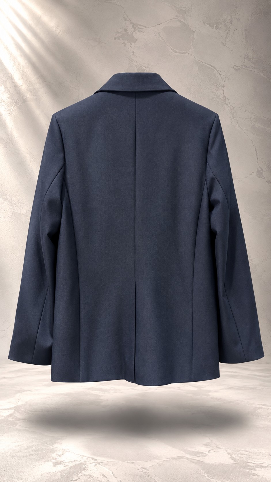 کت تک زنانه سرمه‌ای شیک با یقه انگلیسی و سگک فلزی مینیمال روی پس‌زمینه بتنی روشن | Tailored navy blue women’s blazer with modern metallic buckle closure floating against a minimal concrete background