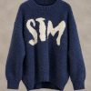 پلیور بافت تدی ضخیم با تایپوگرافی برجسته STM بر روی سینه در استودیوی مینیمال | Bouclé knit sweater with textured green STM front typography floating in minimal studio setting