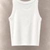 تاپ کراپ کبریتی بافت‌دار بدون آستین یقه گرد معلق در پس‌زمینه مینیمال بتنی | Ribbed sleeveless crop tank top with round neck floating against a minimalist textured background