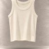 تاپ کراپ کبریتی بافت‌دار بدون آستین یقه گرد معلق در پس‌زمینه مینیمال بتنی | Ribbed sleeveless crop tank top with round neck floating against a minimalist textured background