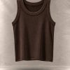 تاپ کراپ کبریتی بافت‌دار بدون آستین یقه گرد معلق در پس‌زمینه مینیمال بتنی | Ribbed sleeveless crop tank top with round neck floating against a minimalist textured background