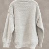 پلیور بافت تدی ضخیم با تایپوگرافی برجسته STM بر روی سینه در استودیوی مینیمال | Bouclé knit sweater with textured green STM front typography floating in minimal studio setting
