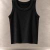 تاپ کراپ کبریتی بافت‌دار بدون آستین یقه گرد معلق در پس‌زمینه مینیمال بتنی | Ribbed sleeveless crop tank top with round neck floating against a minimalist textured background